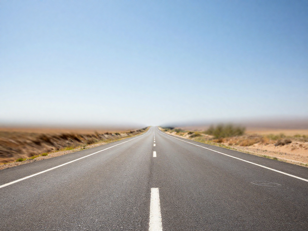 Heat shimmer rising from a hot road on a sunny day, distorting the distant view